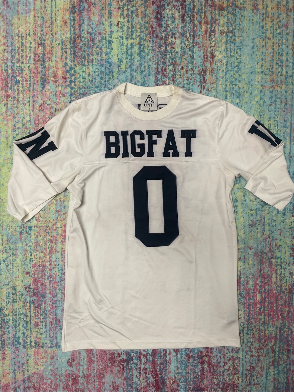 UNIF White Jersey Tee with Black Varsity Graphics